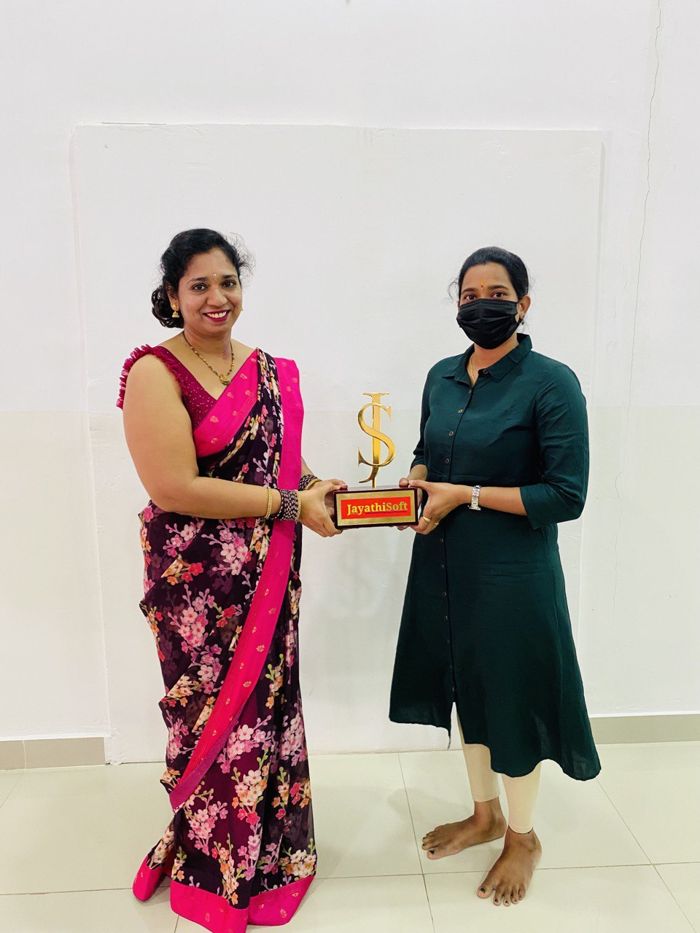 JayathiSoft student celebrating her placement with the trophy